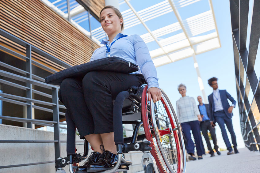 Disabled business woman on ramp in front of the office for inclusion and accessibility