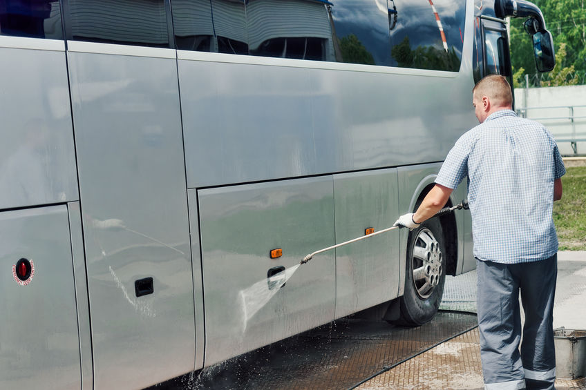 Man cleaning a bus preparing for the spring season