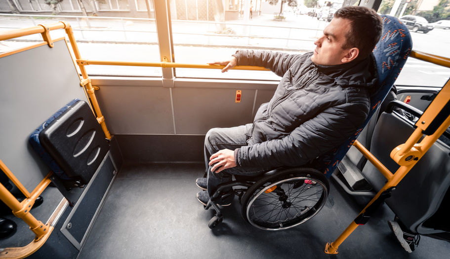 Person with a physical disability inside public transport with an accessible ramp