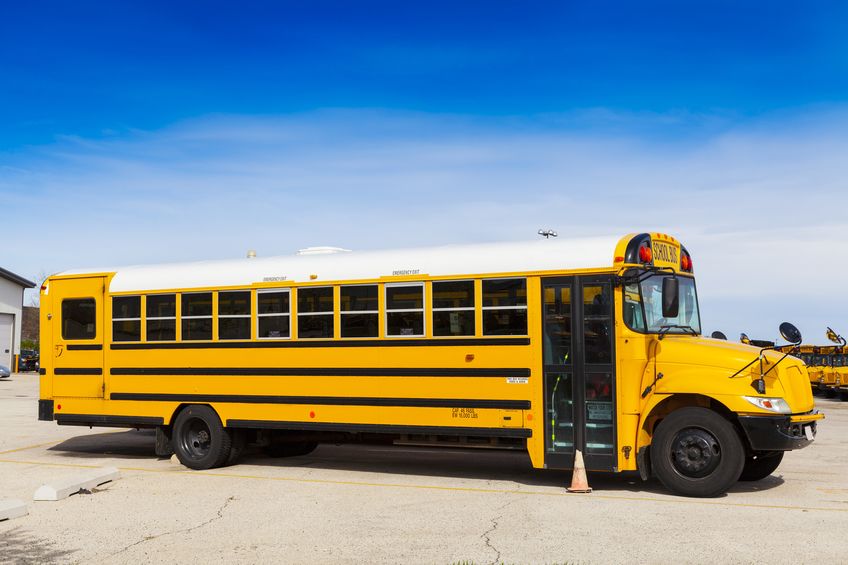yellow school bus with blue sky